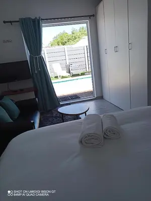 a bedroom with a bed with two towels on it at Stay Palm 2 in Cape Town