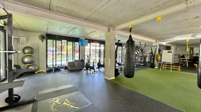 a gym with a fitness room with punching bags at Luxury Beach Apartment in Cape Town