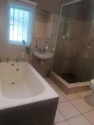 a bathroom with a tub and a sink and a shower at Calmness in Claremont in Cape Town