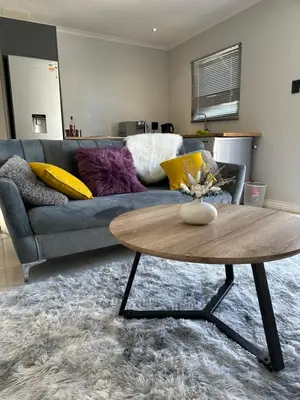 a living room with a couch and a coffee table at Urban Cosy City Haven in Cape Town