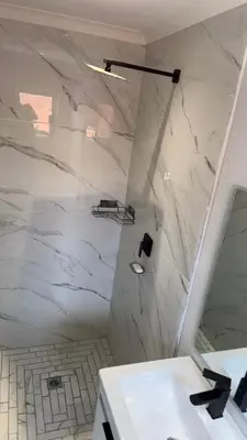 a white bathroom with a sink and a mirror at Urban Cosy City Haven in Cape Town