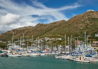 a bunch of boats are docked in a harbor at First Group Cape Gordonia in Gordonʼs Bay