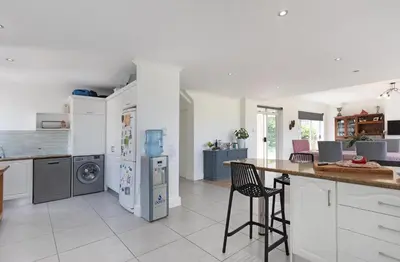 a kitchen with white cabinets and a counter top at Sunset Westchester Villa in Cape Town