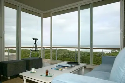 a living room with a view of the ocean at Mosselberg on Grotto Beach in Hermanus
