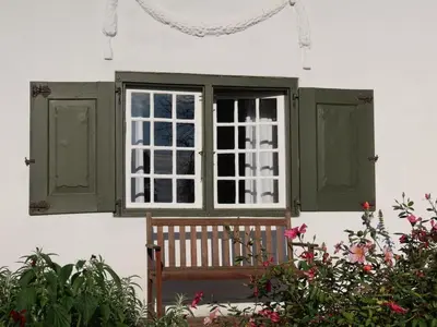 a bench sitting in front of a window at Navarre Residence in Stellenbosch