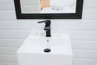 a bathroom with a white sink and a mirror at Tranquil Private Rooms Hermanus in Hermanus