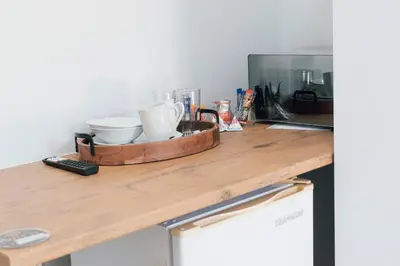 a kitchen counter with a tray of dishes on it at Tranquil Private Rooms Hermanus in Hermanus