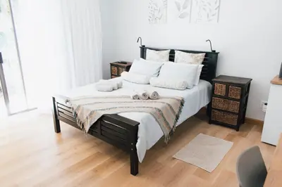 a bedroom with a bed with two towels on it at Tranquil Private Rooms Hermanus in Hermanus