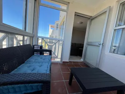 a living room with a couch and a table at #One6Eight in Hermanus