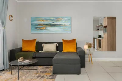 a living room with a couch and a table at Mayfair 219 in Cape Town