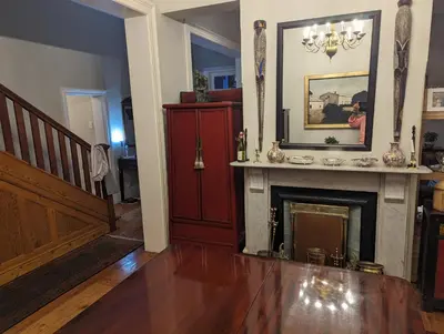 a living room with a fireplace and a staircase at La Montagne Observatory in Cape Town