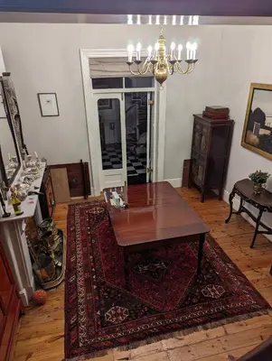 a living room with a table and a rug at La Montagne Observatory in Cape Town