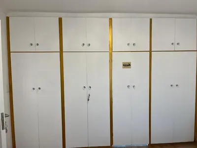 a row of white cabinets in a room at Top Floor Executive apartment in Cape Town