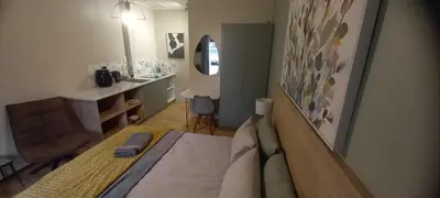 a small room with a bed and a sink at Bellville Self Catering in Cape Town
