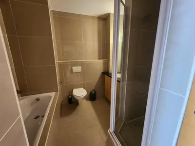 a small bathroom with a shower and a toilet at Hibernian Towers 1203 in Strand