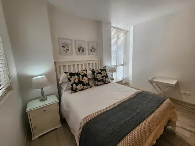 a bedroom with a bed and a lamp on a night stand at Hibernian Towers 1203 in Strand