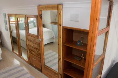a room with a closet with a mirror and a bed at Loft with views in Cape Town