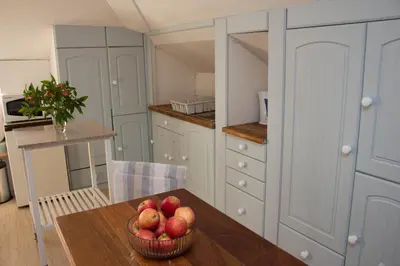 a kitchen with a table with a bowl of apples on it at Loft with views in Cape Town