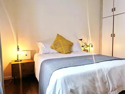 a bedroom with a bed with a yellow pillow on it at 28 on Ryneveld in Stellenbosch