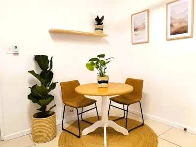 a table with two chairs and a table with a plant at 28 on Ryneveld in Stellenbosch
