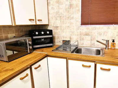 a kitchen with a sink and a microwave at 28 on Ryneveld in Stellenbosch