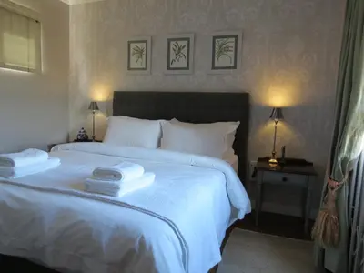 a bedroom with a white bed with two towels on it at 10 on Berg in Villiersdorp