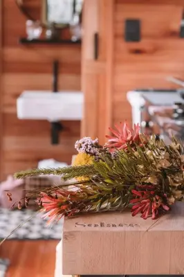 a box with a bouquet of flowers on a table at Luxury Solace Cabin - River Cabin in Rawsonville