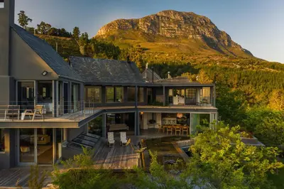 an aerial view of a house with a mountain in the background at Spanish Farm Boutique Hotel & Villas in Somerset West