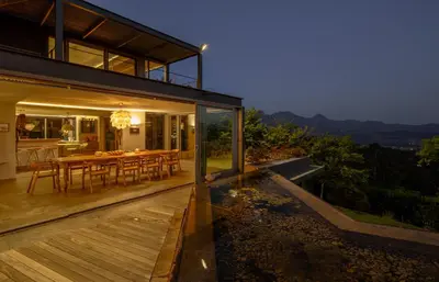 a dining area of a house with a wooden deck at Spanish Farm Boutique Hotel & Villas in Somerset West