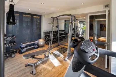 a fitness room with a gym with tread machines at Spanish Farm Boutique Hotel & Villas in Somerset West
