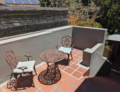 a patio with a table and chairs and a grill at 33 Longifolia in Stellenbosch