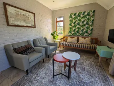 a living room with a couch and a table at 33 Longifolia in Stellenbosch