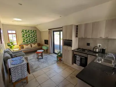 a kitchen and a living room with a couch at 33 Longifolia in Stellenbosch
