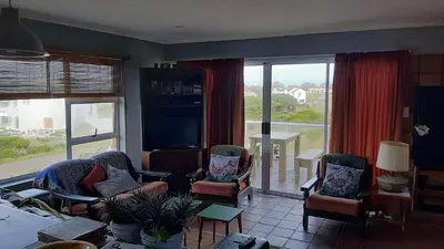 a living room with chairs and a large window at Betty's Bay Holiday home in Clareport