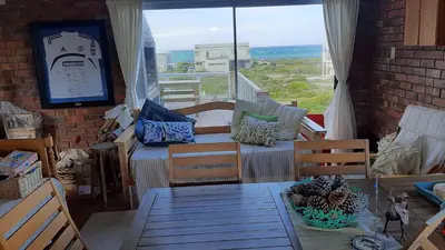 a room with a table and chairs and a window at Betty's Bay Holiday home in Clareport