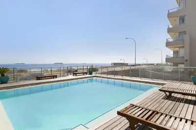 a swimming pool on the roof of a building at Sea Spray AG04 in Bloubergstrand