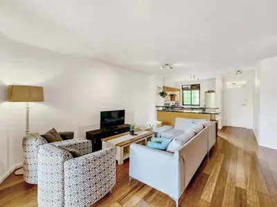 a living room with two couches and a tv at Pool, Gym, self check-in,Parking in Cape Town