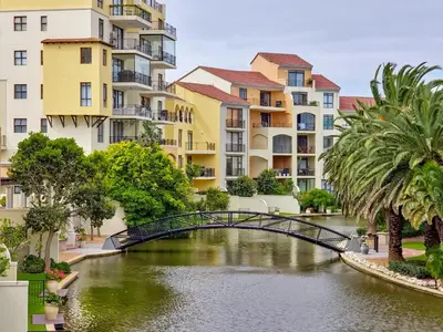 a bridge over a river with buildings at Pool, Gym, self check-in,Parking in Cape Town
