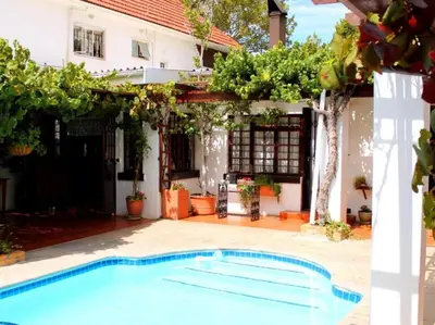 a swimming pool in front of a house at Linge Longa in Worcester