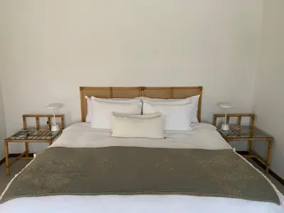 a bedroom with a bed with two end tables at Barford Haven in Hermanus