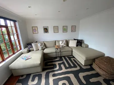 a living room with a couch and a rug at Barford Haven in Hermanus