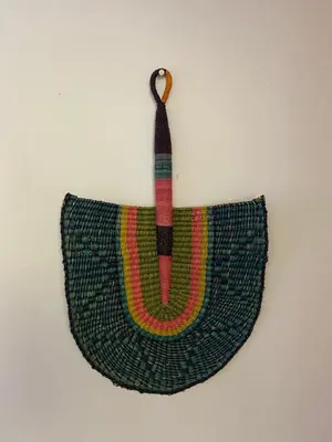 a green crochet bag hanging on a wall at Barford Haven in Hermanus