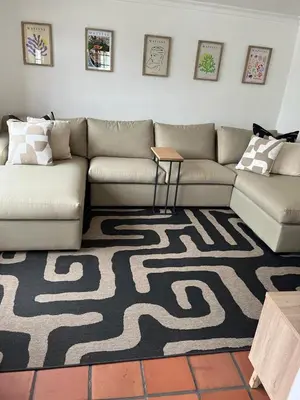 a living room with a couch and a carpet at Barford Haven in Hermanus