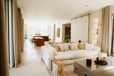 a living room with a white couch and a table at MAISON FRANSCHHOEK in Franschhoek
