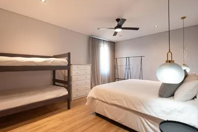 a bedroom with two bunk beds and a ceiling fan at Villa Paradys - Serviced in Stellenbosch