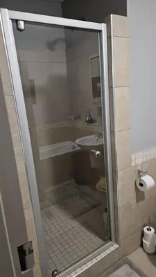 a bathroom with a shower with a toilet and a sink at SS Luxury Apartments in Cape Town