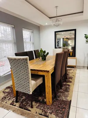 a dining room with a wooden table and chairs at Entertainers delight near the beach & wine routes in Cape Town