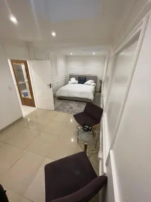 a small room with a bed and a chair at DOMIN LUXURY SUITES in Cape Town