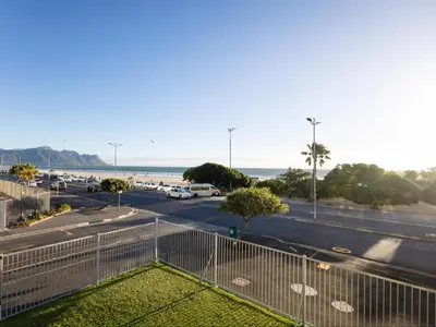 a view of a parking lot and the beach at St Tropez Beachfront 101 in Strand