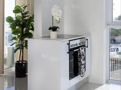 a kitchen with a counter with a stove at St Tropez Beachfront 101 in Strand